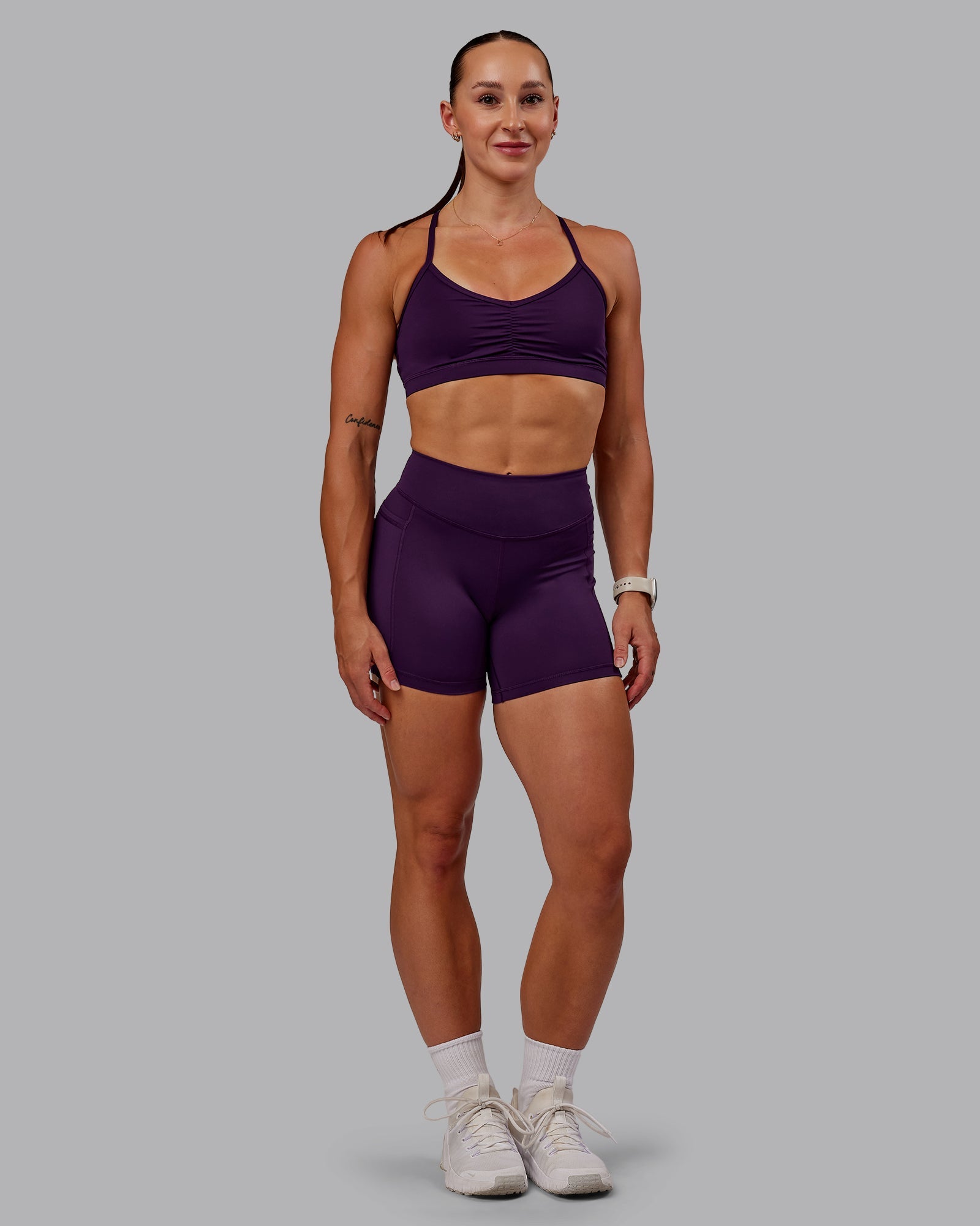 Woman wearing Elite High-Rise 4" Short Pockets - Deep Purple | Size:S
