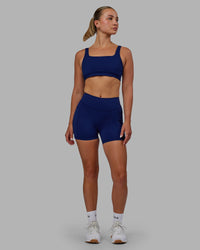 Woman wearing Elite High-Rise 4" Short Pockets - Midnight Blue