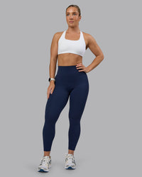 Woman wearing Elixir Ultra High-Rise 7/8 Legging - Future Navy