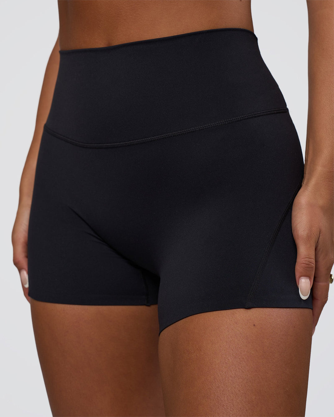 Woman wearing Elixir Defined High-Rise 4&quot; Short Pockets - Black | Model:Bianca | Size:S