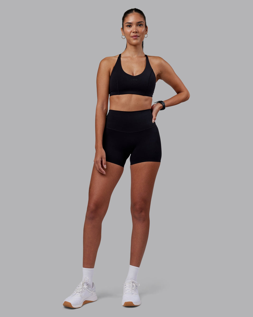 Woman wearing Elixir High-Rise 4&quot; Short - Black | Model:Rhiley | Size:S