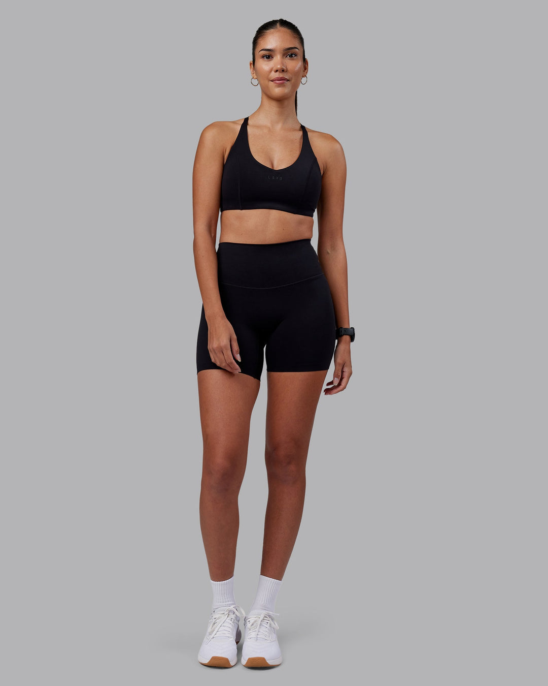 Woman wearing Elixir High-Rise 6&quot; Short - Black | Model:Rhiley | Size:S
