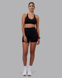 Woman wearing Elixir High-Rise 6" Short - Black | Model:Rhiley | Size:S