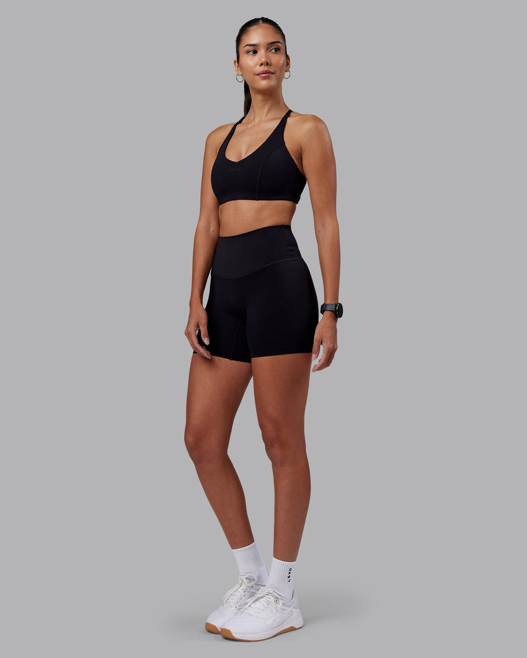 Woman wearing Elixir High-Rise 6&quot; Short - Black | Model:Rhiley | Size:S