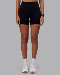 Woman wearing Elixir High-Rise 6" Short - Black | Model:Rhiley | Size:S