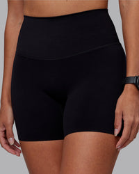 Woman wearing Elixir High-Rise 6" Short - Black | Model:Rhiley | Size:S