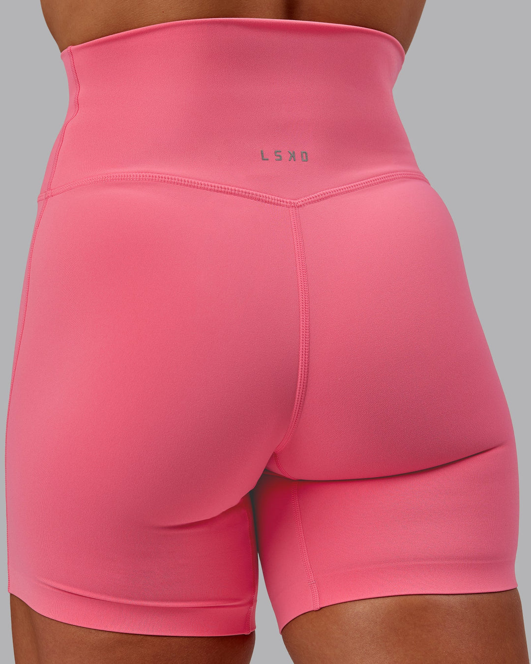 Woman wearing Elixir Mid Short Tight in Pink Lemonade | Size:S