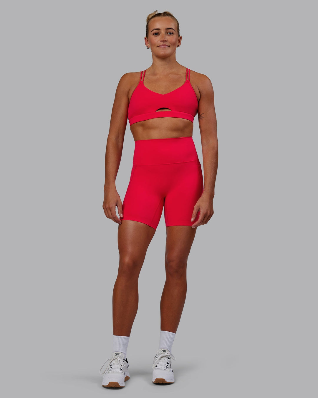 Woman wearing Elixir Mid-Length Shorts with Pockets - Scarlet