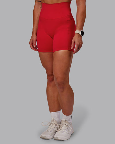 Woman wearing Elixir Mid Short Tight With Pockets in Flame | Size:S