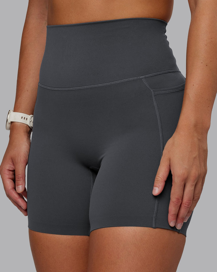 Woman wearing Elixir Mid Short Tight With Pockets in Dark Storm | Size:S
