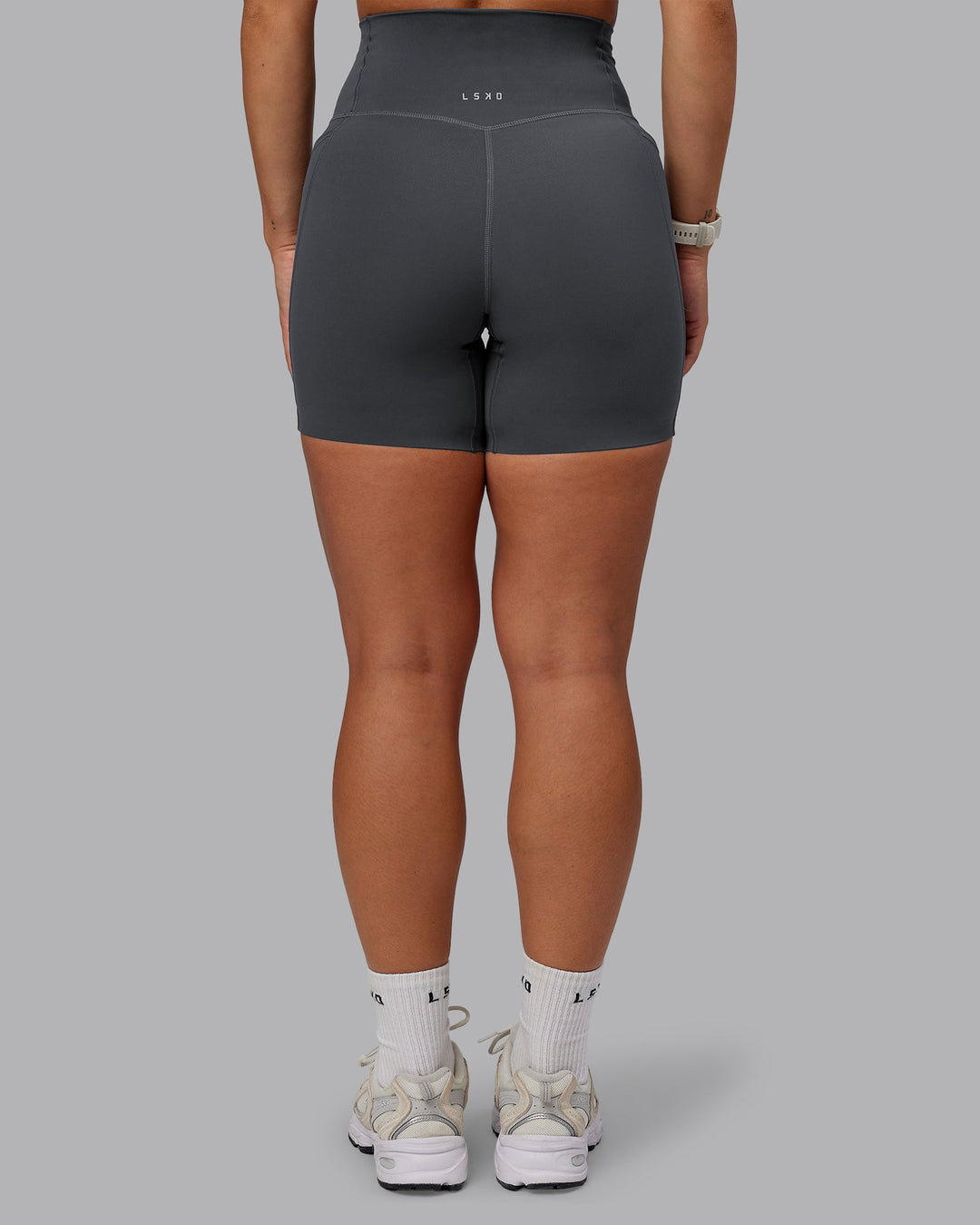 Woman wearing Elixir Mid Short Tight With Pockets in Dark Storm | Size:S