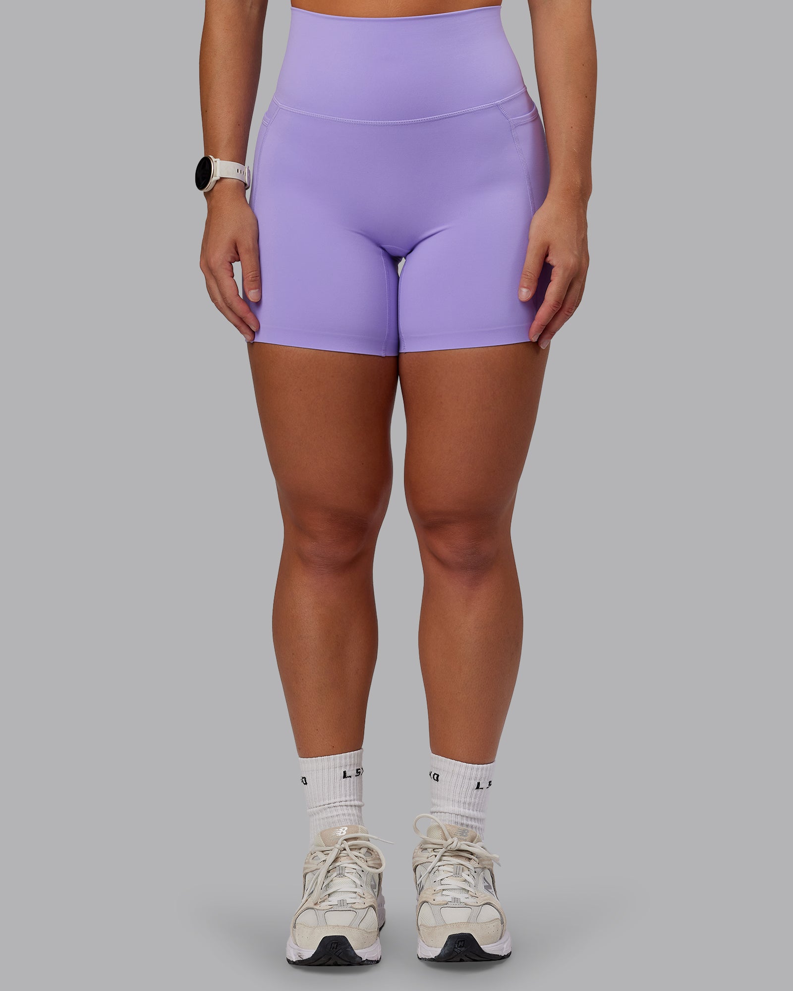 Woman wearing Elixir Ultra High-Rise 6" Short Pockets in Violet Ray | Size:S