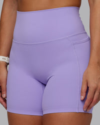 Woman wearing Elixir Ultra High-Rise 6" Short Pockets in Violet Ray | Size:S