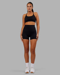 Woman wearing Elixir Ultra High-Rise 4" Short - Black | Model:Kirstyn | Size:S
