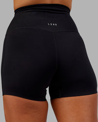 Woman wearing Elixir Ultra High-Rise 4" Short - Black | Model:Kirstyn | Size:S