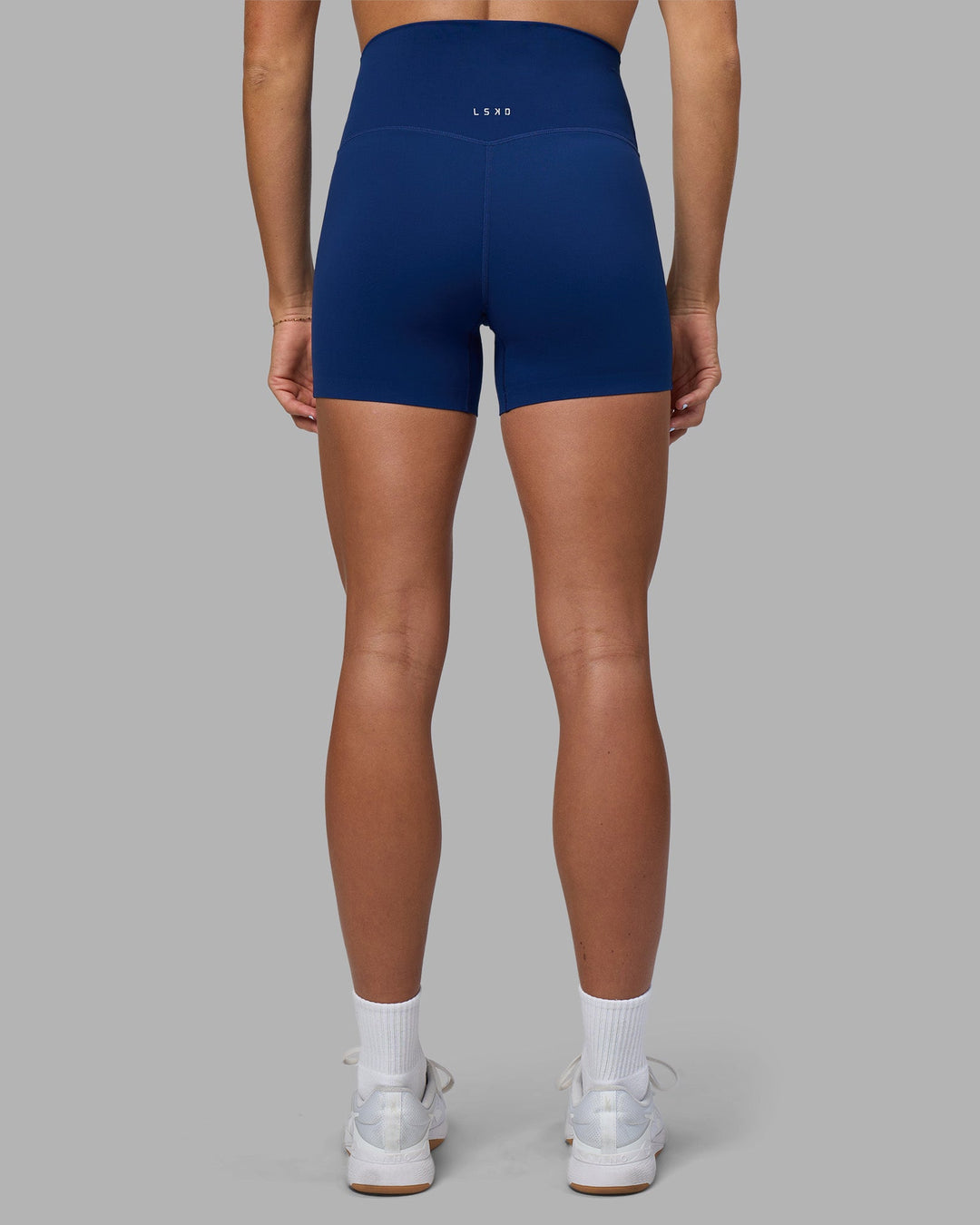 Woman wearing Elixir Ultra High-Rise 4&quot; Short - Midnight Blue | Model:Katie | Size:S
