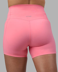 Woman wearing Elixir Ultra High-Rise 4" Short Pockets - Candy Pink | Model:Phoebe | Size:S