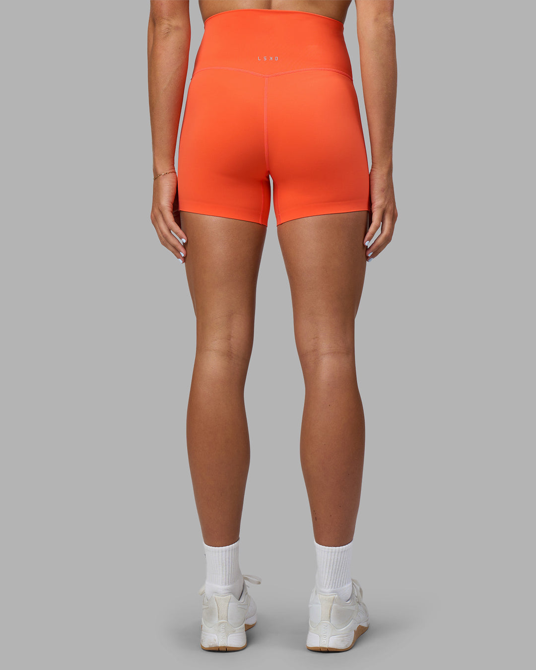 Woman wearing Elixir Ultra High-Rise 4&quot; Short - Ultra Orange | Model:Katie | Size:S