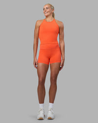 Woman wearing Elixir Ultra High-Rise 4" Short - Ultra Orange | Model:Katie | Size:S