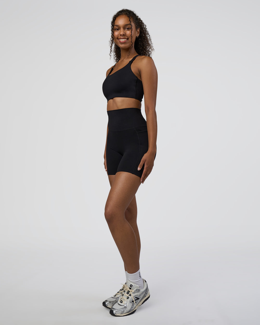 Woman wearing Elixir Ultra High-Rise 6&quot; Short Pockets - Black | Model:Jordan | Size:S