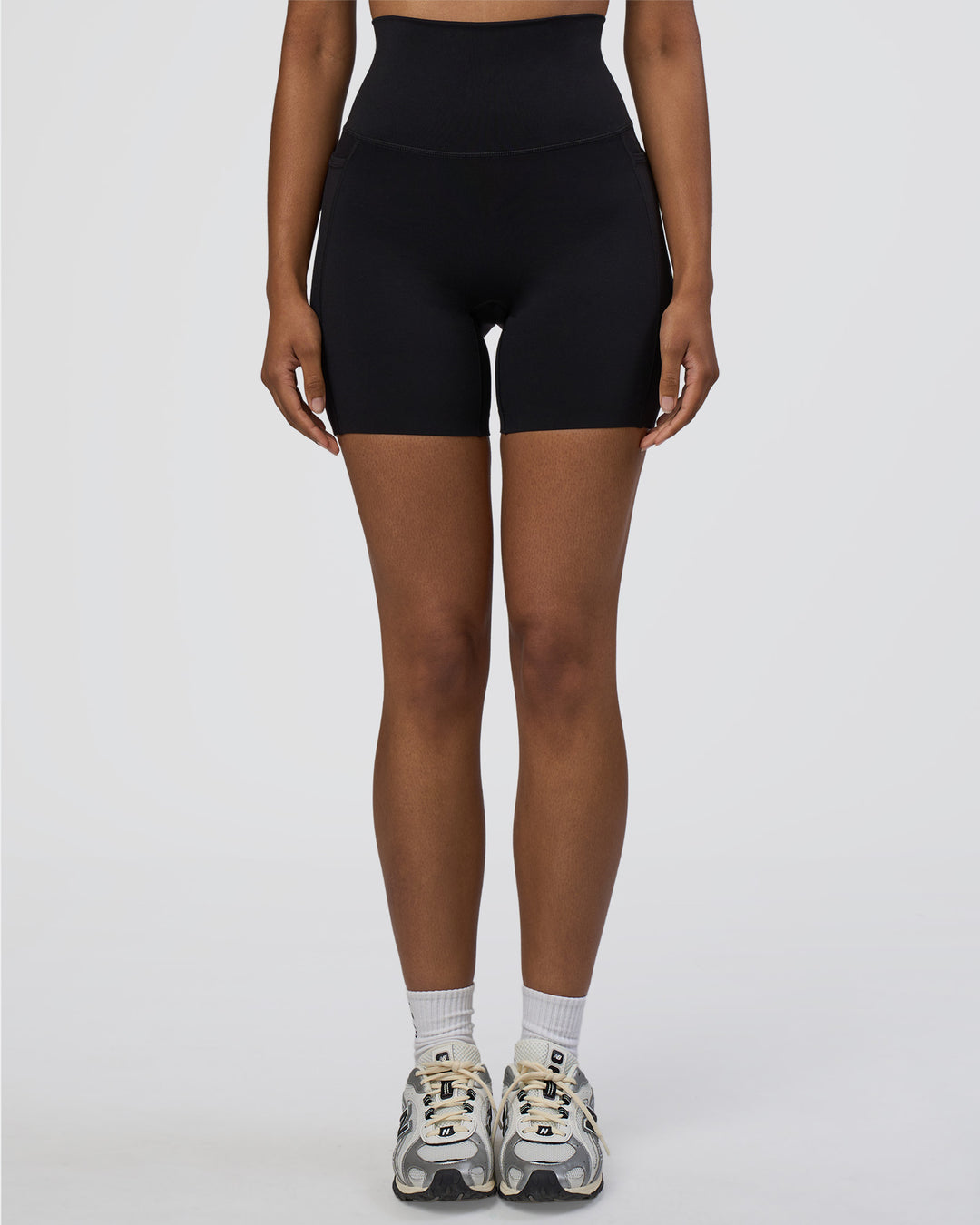 Woman wearing Elixir Ultra High-Rise 6&quot; Short Pockets - Black | Model:Jordan | Size:S