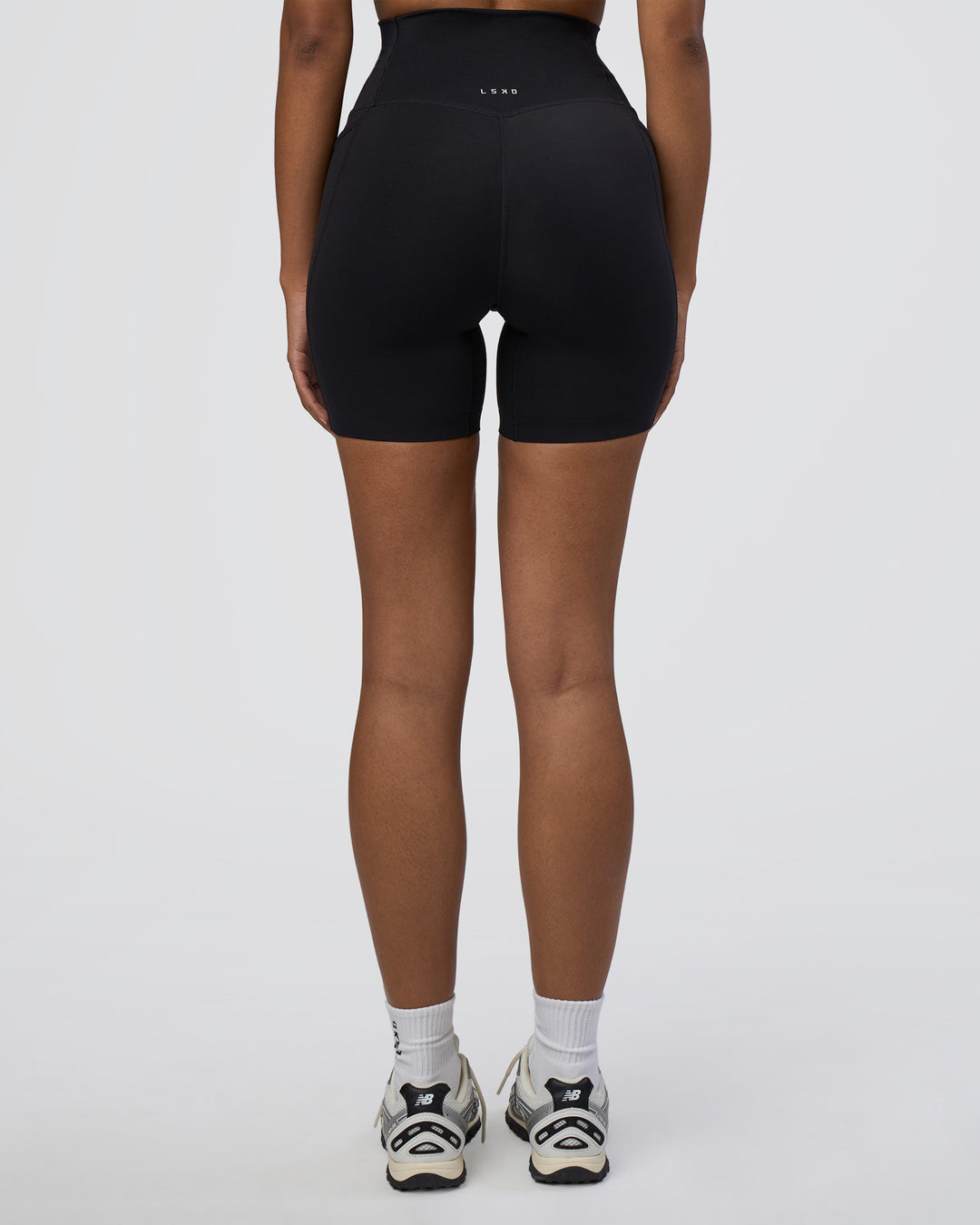 Woman wearing Elixir Ultra High-Rise 6&quot; Short Pockets - Black | Model:Jordan | Size:S