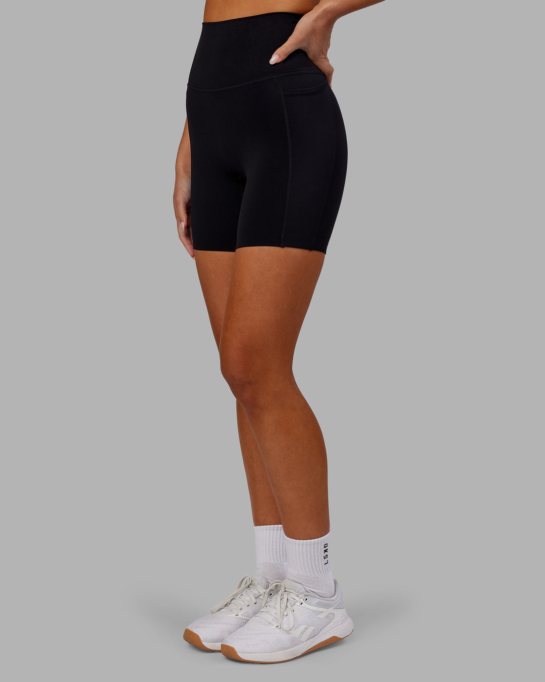 Woman wearing Elixir Ultra High-Rise 6&quot; Short Pockets - Black | Model:Kirstyn | Size:S