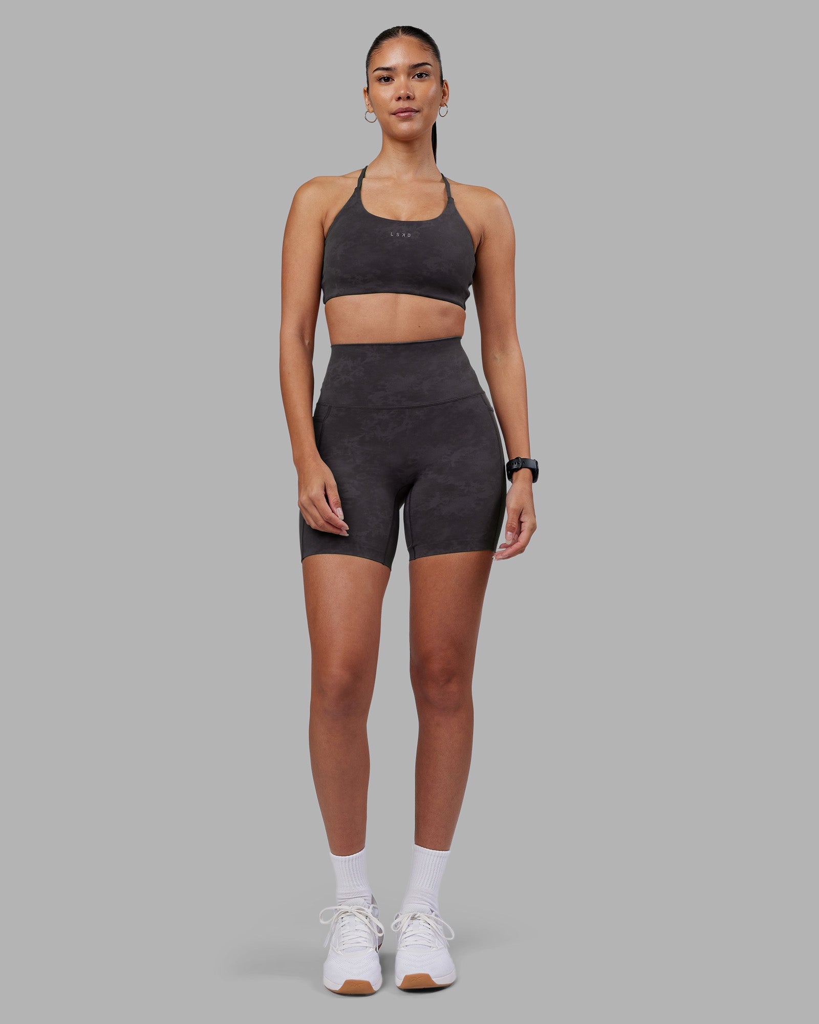 Woman wearing Elixir Ultra High-Rise 6" Short Pockets - Dark Storm Wash | Model:Rhiley | Size:S