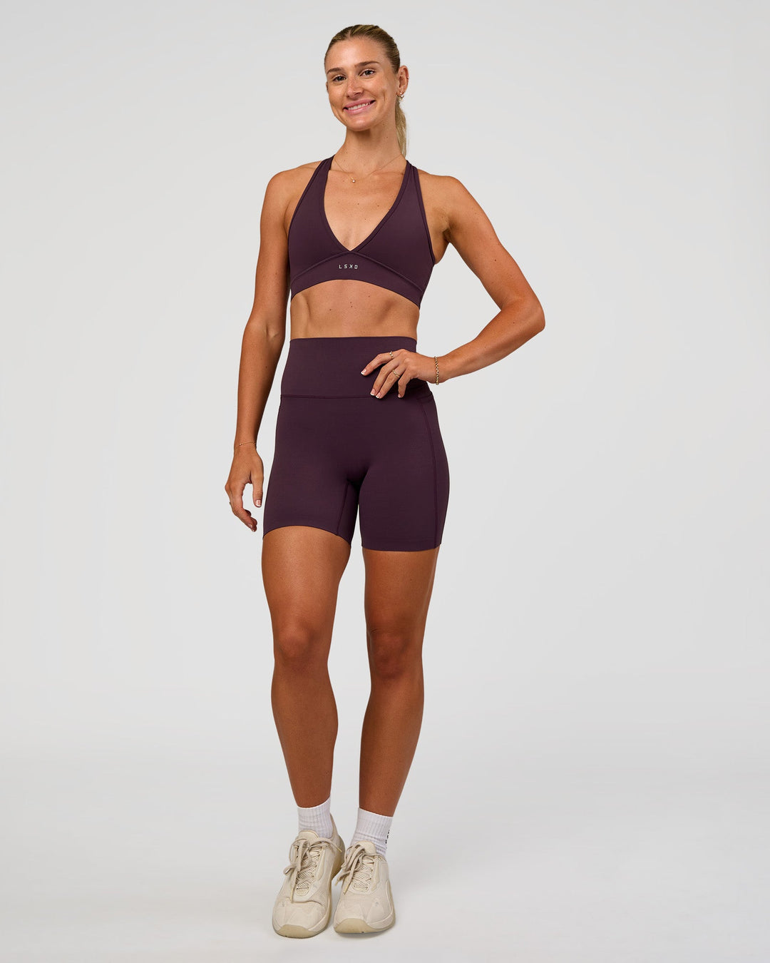 Woman wearing Elixir Ultra High-Rise 6” Short Pockets - Midnight Plum | Model:Emelia | Size:S
