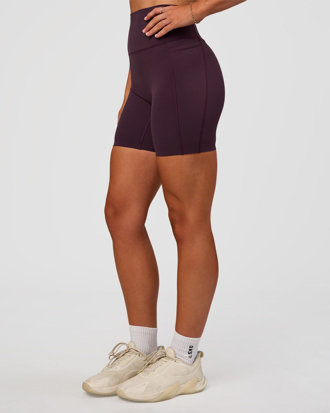 Woman wearing Elixir Ultra High-Rise 6” Short Pockets - Midnight Plum | Model:Emelia | Size:S