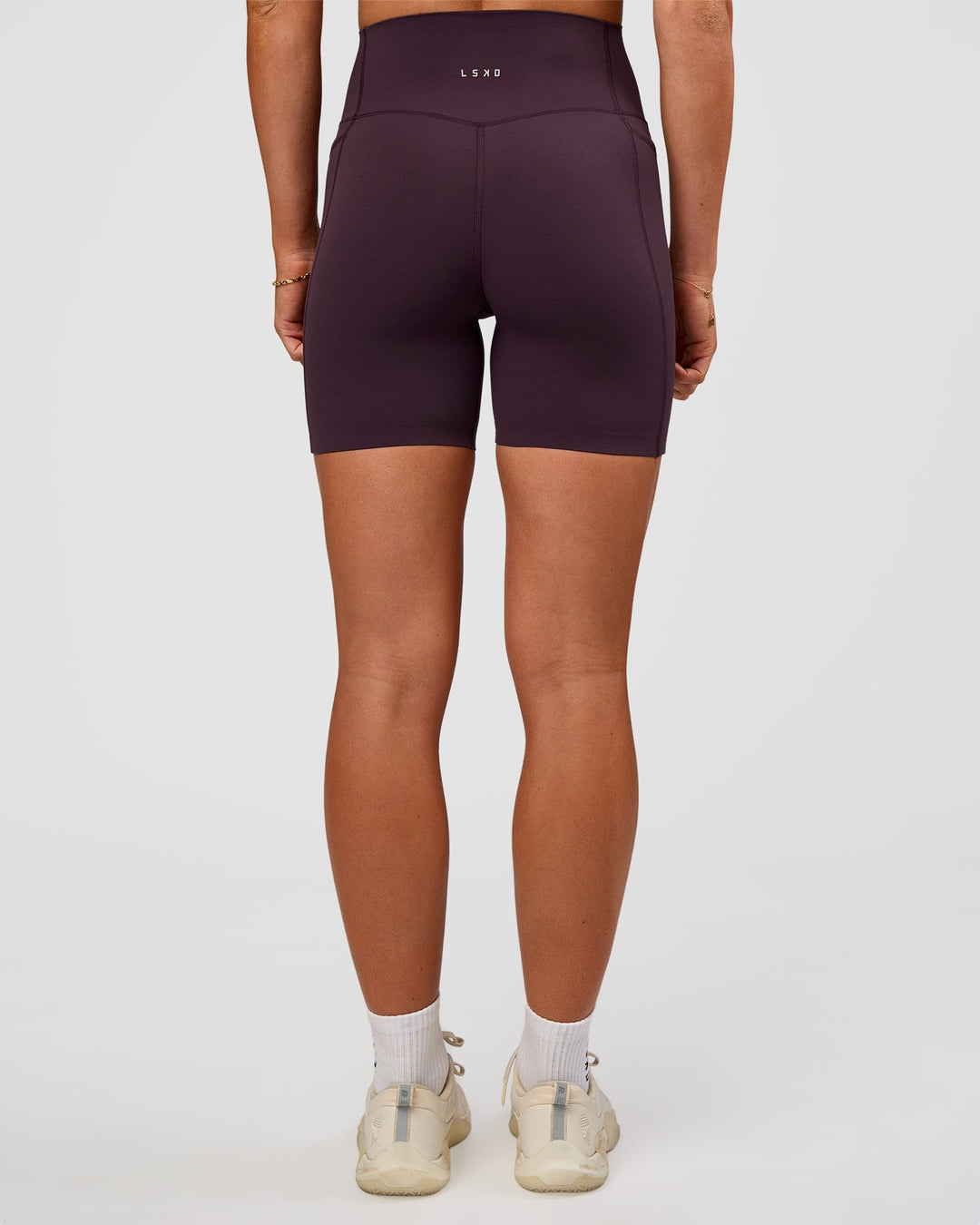 Woman wearing Elixir Ultra High-Rise 6” Short Pockets - Midnight Plum | Model:Emelia | Size:S