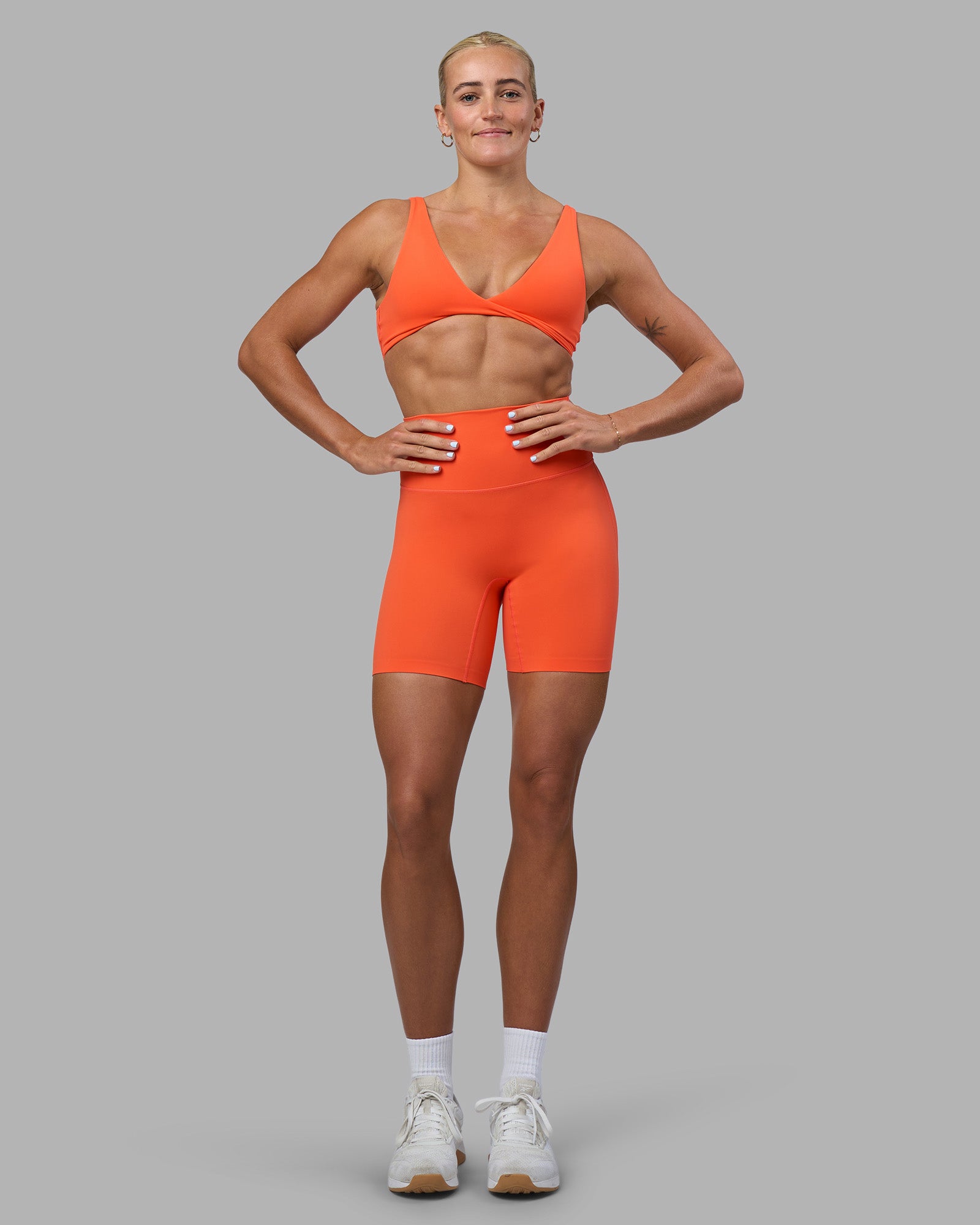 Woman wearing Elixir Ultra High-Rise 6" Short - Ultra Orange | Model:Katie | Size:S