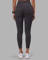 Woman wearing Elixir Ultra High-Rise 7/8 Legging Pockets - Dark Storm Wash | Model:Rhiley | Size:S | Thumbnail Index: 4
