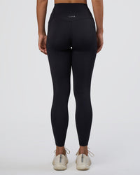Woman wearing Elixir Ultra High-Rise Full Length Legging Pockets - Black | Model:Amity | Size:S