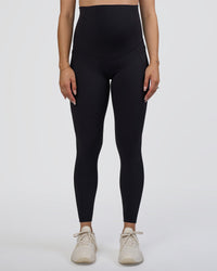 Woman wearing Elixir Ultra High-Rise Maternity Full Length Legging Pockets - Black | Model:Kitahna | Size:S