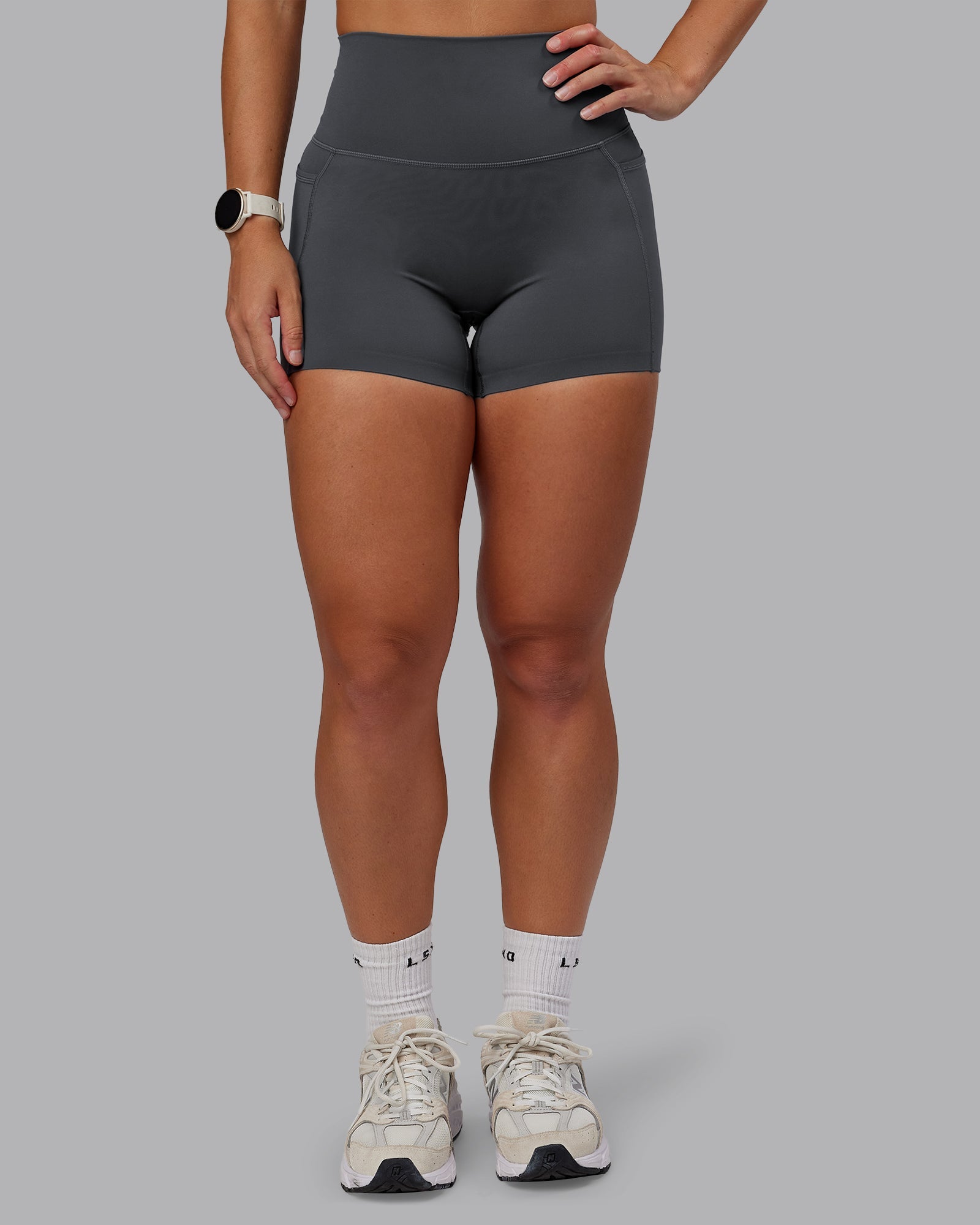 Woman wearing Elixir Ultra High-Rise 4" Short Pockets in Dark Storm | Size:S