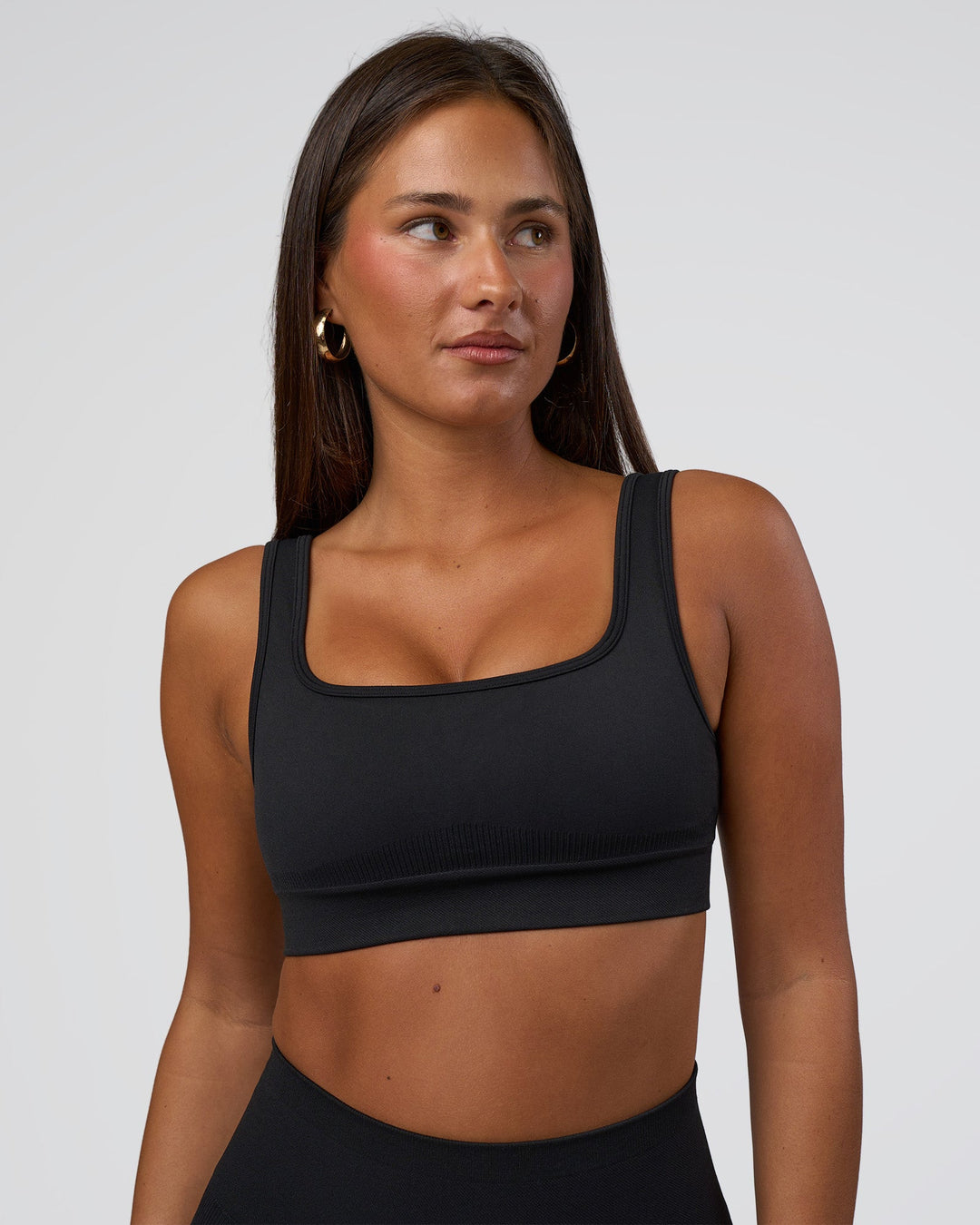 Woman wearing Ember Seamless Sports Bra - Black | Model:Brylee | Size:XS - view 6