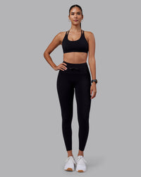 Woman wearing Empower Sports Bra - Black | Model:Rhiley | Size:S