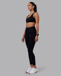 Woman wearing Empower Sports Bra - Black | Model:Rhiley | Size:S