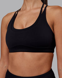 Woman wearing Empower Sports Bra - Black | Model:Rhiley | Size:S