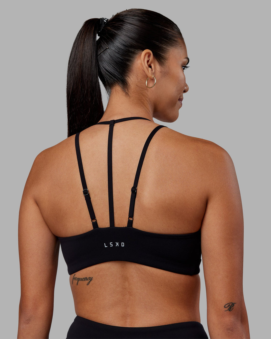 Woman wearing Empower Sports Bra - Black | Model:Rhiley | Size:S