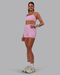 Woman wearing Enhance Ultra High-Rise 4" Short - Pink Frosting | Model:Phoebe | Size:S