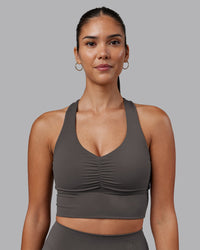 Woman wearing Evoke Longline Sports Bra - Dark Storm | Model:Rhiley | Size:S
