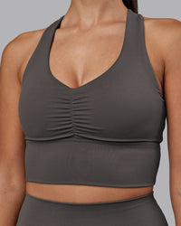 Woman wearing Evoke Longline Sports Bra - Dark Storm | Model:Rhiley | Size:S