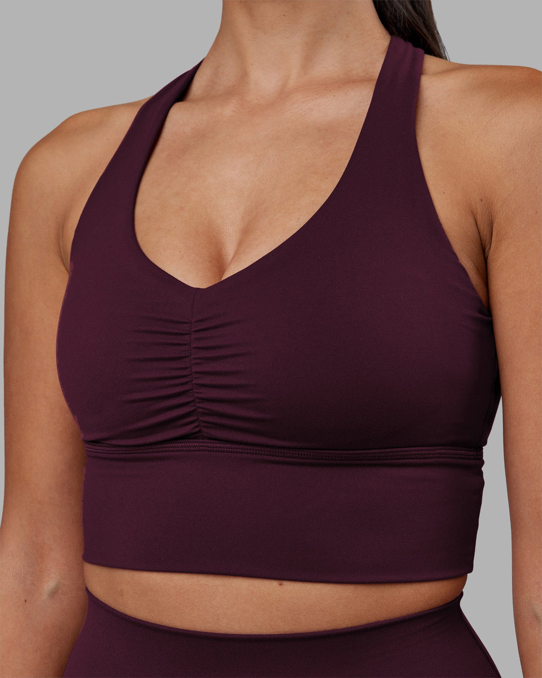 Woman wearing Evoke Longline Sports Bra - Cherry Lacquer | Model:Rhiley | Size:S
