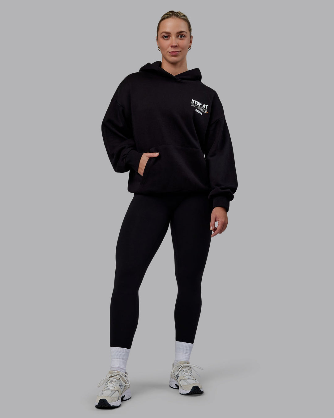 Woman wearing Unisex Fitstop Stop at Nothing Hoodie Oversize - Black