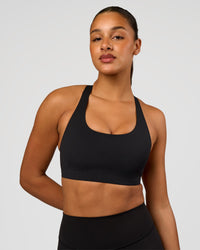 Woman wearing Flow Bonded Scoop Neck Sports Bra - Black | Model:Rosie | Size:S