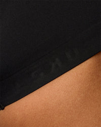 Woman wearing Flow Bonded Scoop Neck Sports Bra - Black | Model:Rosie | Size:S