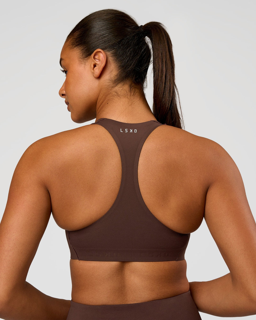 Woman wearing Flow Bonded Scoop Neck Sports Bra - Hot Chocolate | Model:Rosie | Size:S