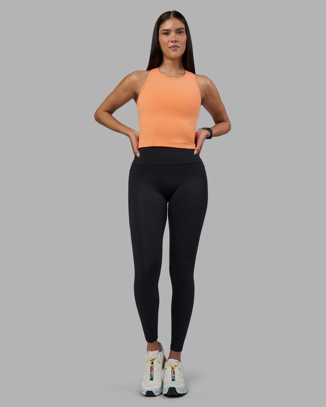 Woman wearing Flow Performance Tank 2.0 - Cantaloupe | Model:Rhiley | Size:S